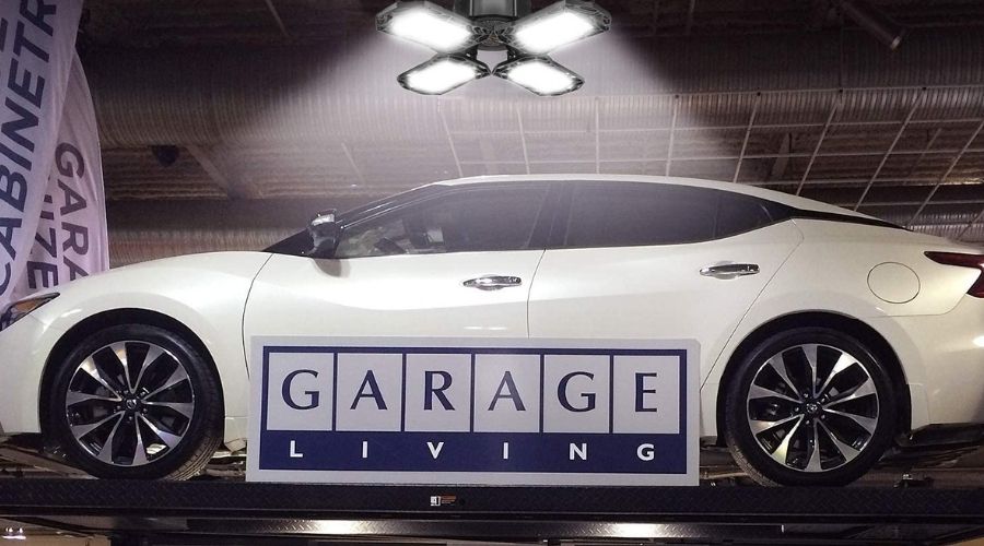 A picture of 2-Pack LED Garage Lights 120W Garage Lighting, 12000LM, one of the best LED lights for garage being used to illuminate the garage surface during a car service 