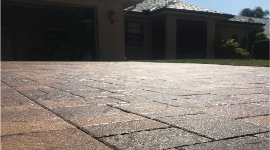 An image showing how effectiveness 5 Gallon DOMINATOR SG+ High Gloss Paver Sealer and Decorative Concrete, one of the best cocrete sealer for garage has been used to seal the concrete floor 