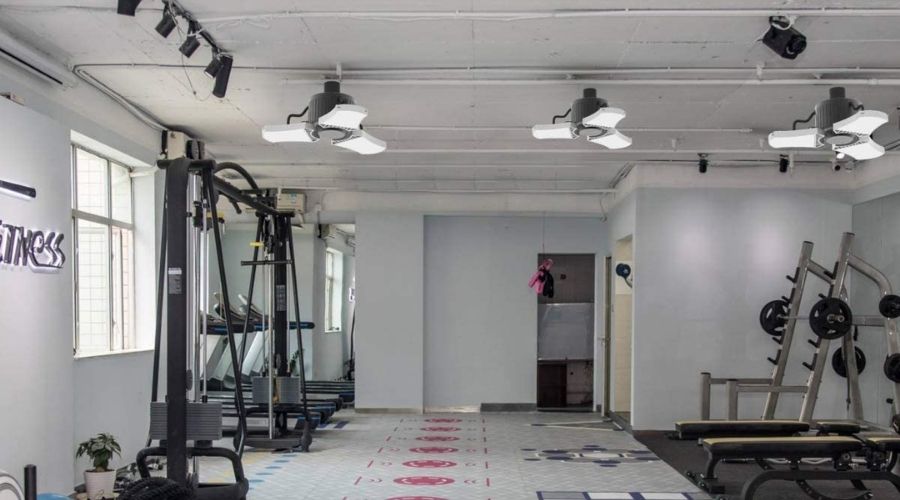 Pictoirial reprsentation of Lightdot 2 Pack LED Garage Light with Motion Sensor, 6000LM(60W Eqv 200W) in use in a gym, showing how the best lights for garage ceiling can be applied to many uses at home 