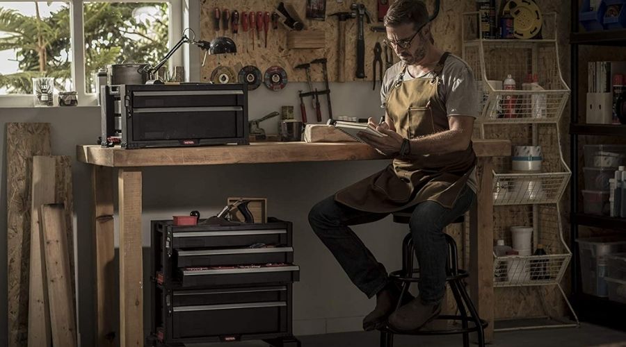 An image of a mechanc in a garage with arranged equipment in a Keter Rolling Tool Chest with Storage Drawers, one of the best tool chest for garage 