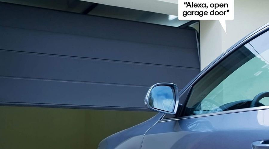 An image of Atomi Smart Garage Door Opener - Built-in Camera, WiFi-Compatible with Alexa, Google Assistant, iOS, Android, and the Atomi Smart App, Wireless Control, one of the best smart garage door opener units in use to open a garage door through connection with an alexa