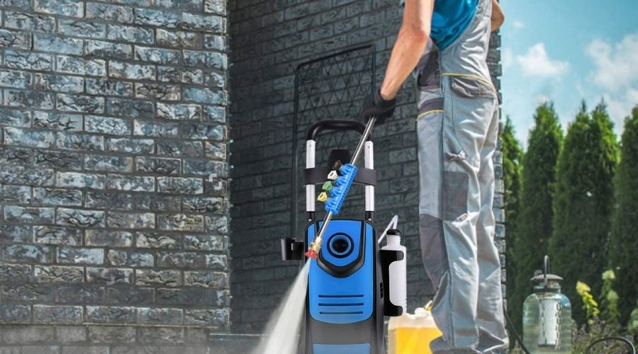 An image of a man using Suyncll Pressure Washer 3800PSI Max 2.8 GPM Electric Pressure Washer High Power Washer Machine Cleaner with Nozzles to pressure wash a floor 