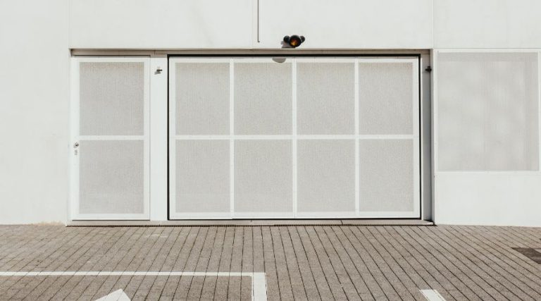An image of garage door operated by a remote control